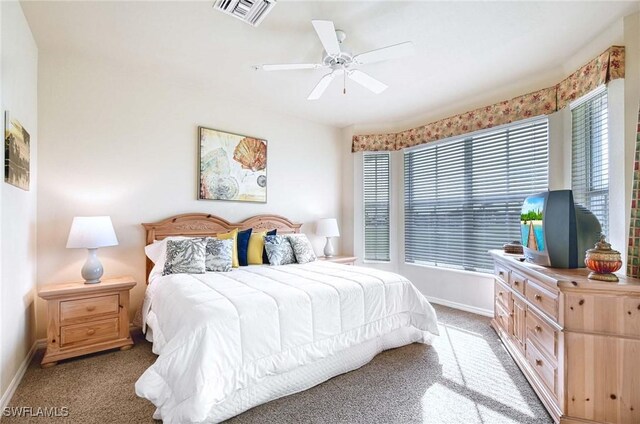 bedroom with ceiling fan and light colored carpet