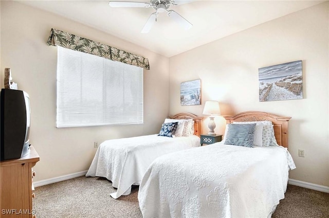 bedroom with a ceiling fan, baseboards, and carpet flooring