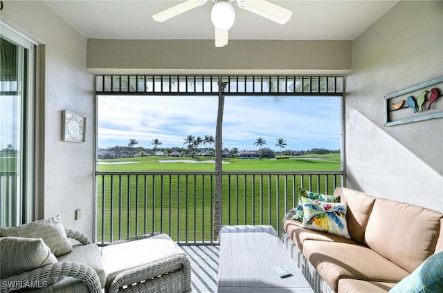 sunroom / solarium featuring ceiling fan