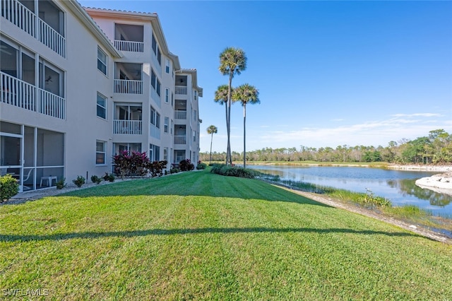 view of community featuring a yard and a water view