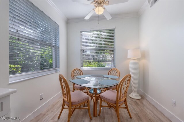 dining area with light hardwood / wood-style flooring, ceiling fan, and ornamental molding