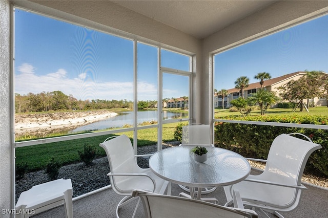 sunroom / solarium with a water view