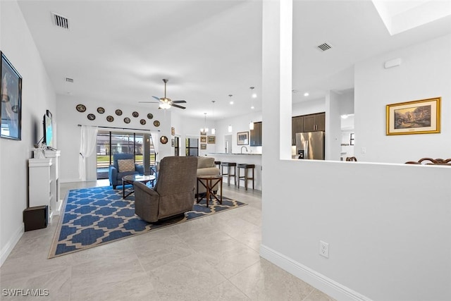 living room featuring light tile patterned floors and ceiling fan