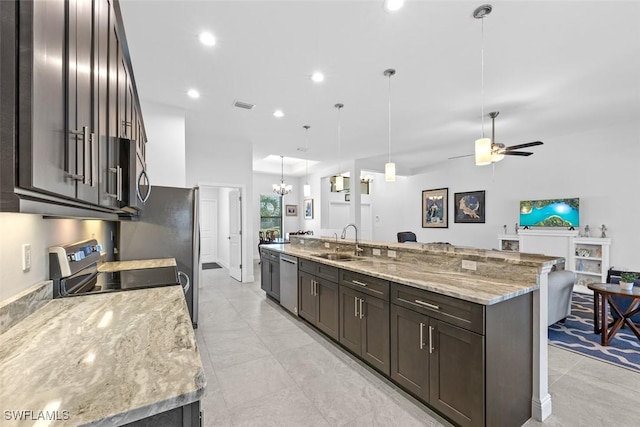 kitchen featuring dishwasher, ceiling fan with notable chandelier, a spacious island, sink, and hanging light fixtures