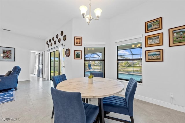 tiled dining room featuring a notable chandelier