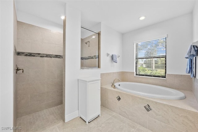 bathroom featuring tile patterned floors and shower with separate bathtub