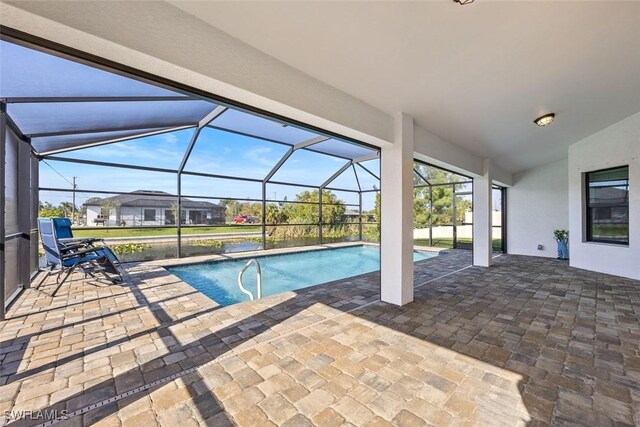 view of swimming pool with glass enclosure and a patio area