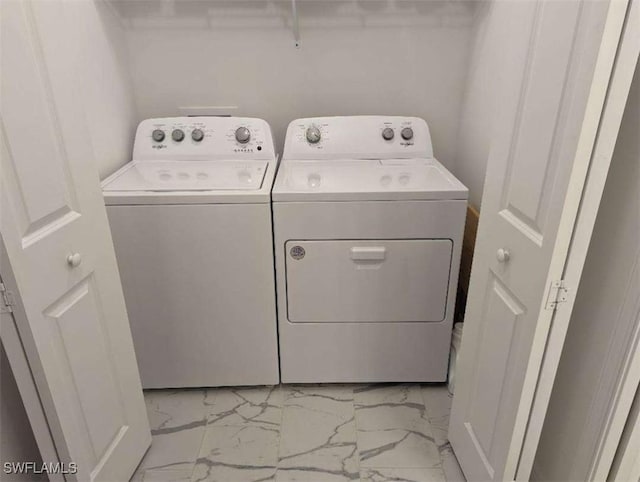 clothes washing area featuring washer and clothes dryer