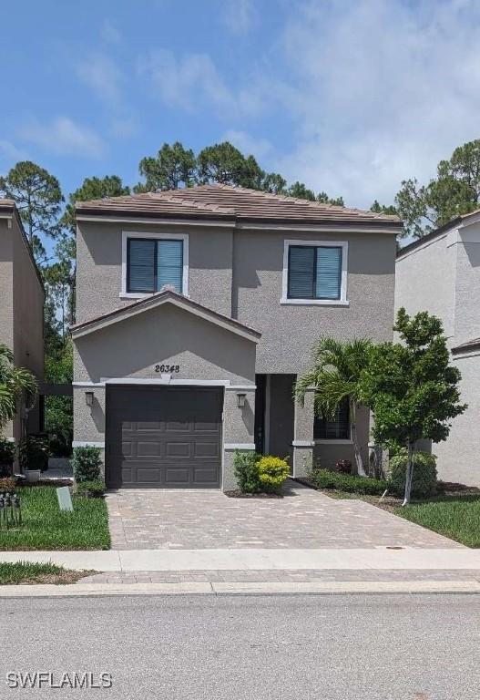 26348 Bonita Fairways Blvd, Bonita Springs, FL 34135 - traditional home with stucco siding, an attached garage, and driveway