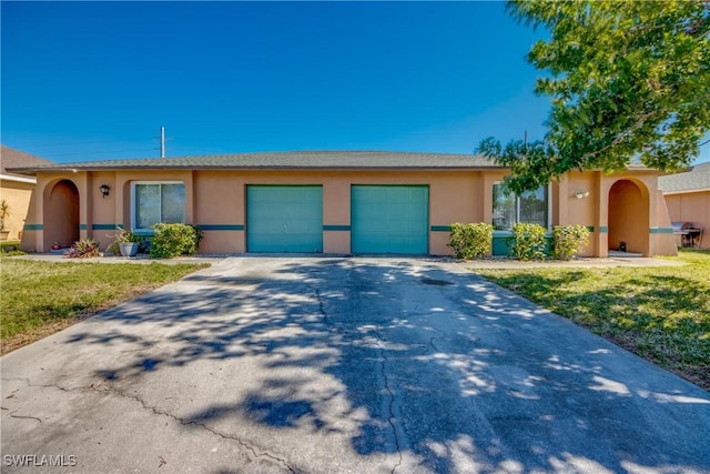 single story home with a front yard and a garage