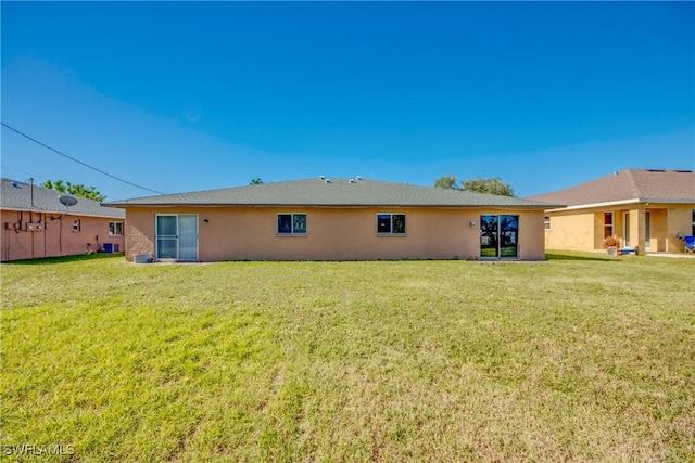 back of property featuring a yard