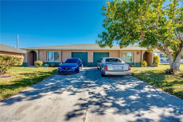 ranch-style house featuring a garage and a front yard