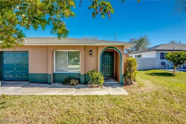 view of front of house with a garage and a front yard