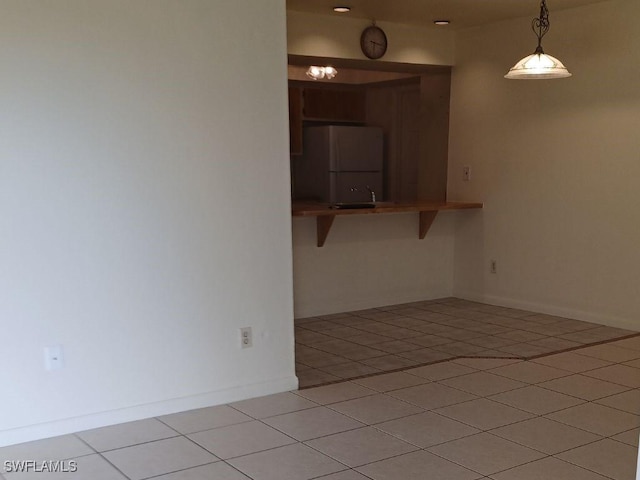 unfurnished room with light tile patterned floors