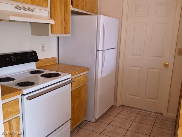 kitchen with white appliances and light tile patterned floors