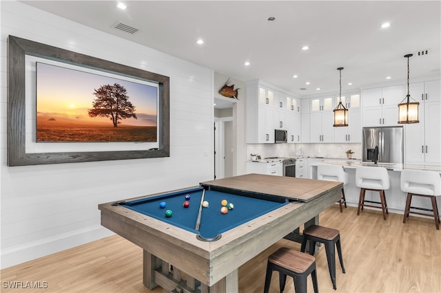 recreation room with light hardwood / wood-style flooring and pool table