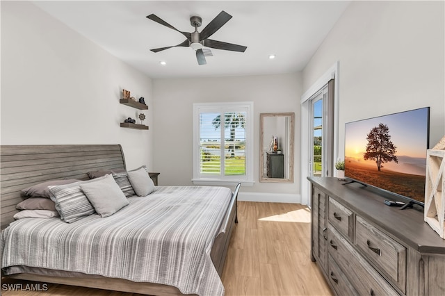 bedroom with ceiling fan and light wood-type flooring