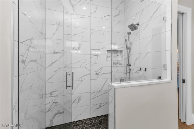 bathroom with a shower with shower door