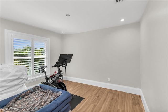 workout area with hardwood / wood-style flooring