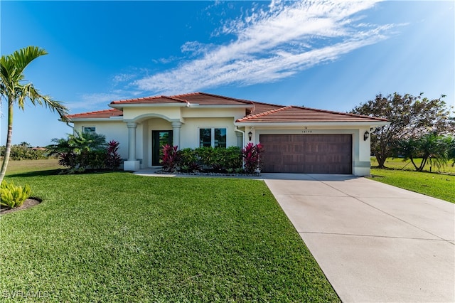 mediterranean / spanish-style house with a garage and a front yard