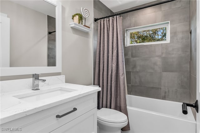 full bathroom featuring shower / bath combo with shower curtain, vanity, and toilet