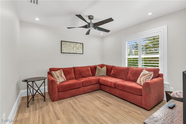 living room featuring ceiling fan and light wood-type flooring