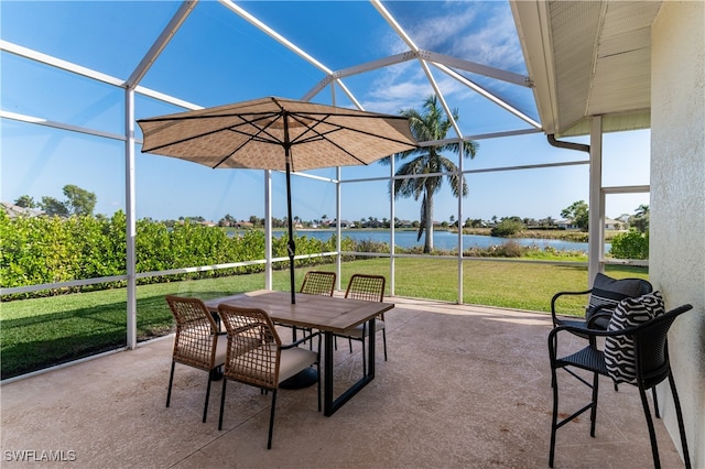 view of patio / terrace with a water view and glass enclosure