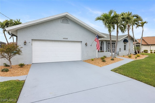 ranch-style home featuring a garage and a front lawn