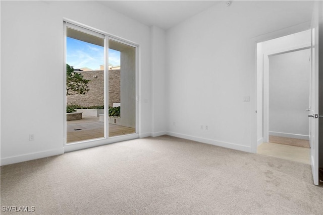 unfurnished room featuring light carpet