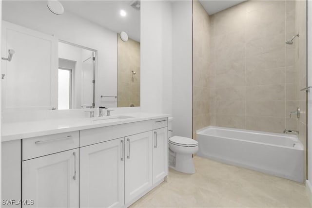 full bathroom featuring toilet, tiled shower / bath, and vanity