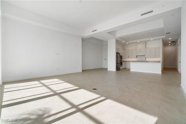 unfurnished living room featuring light tile patterned floors