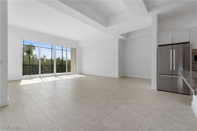 unfurnished living room with light tile patterned flooring