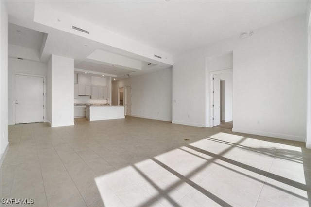 unfurnished living room with light tile patterned floors