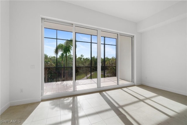 entryway with plenty of natural light and light tile patterned flooring