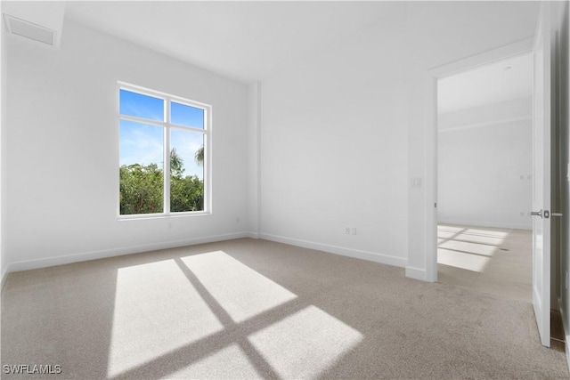 unfurnished room with light colored carpet