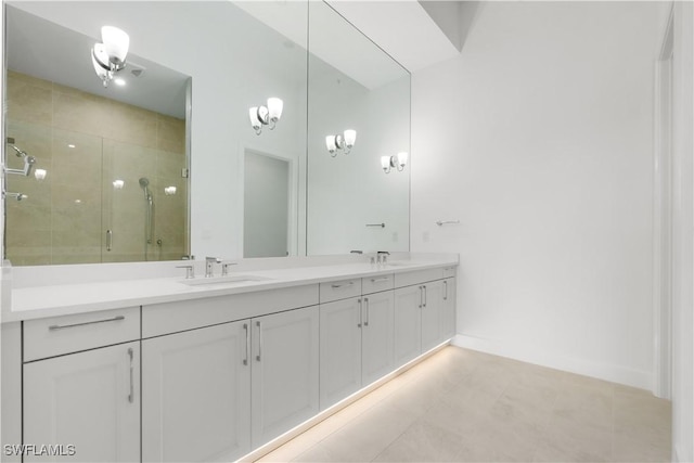 bathroom with an enclosed shower, vanity, and tile patterned floors