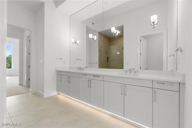 bathroom featuring vanity, tile patterned flooring, walk in shower, and a notable chandelier