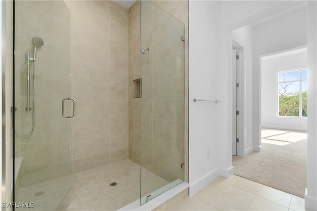 bathroom featuring tile patterned flooring and an enclosed shower