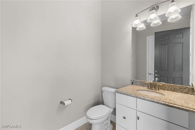 bathroom featuring tile patterned floors, vanity, and toilet