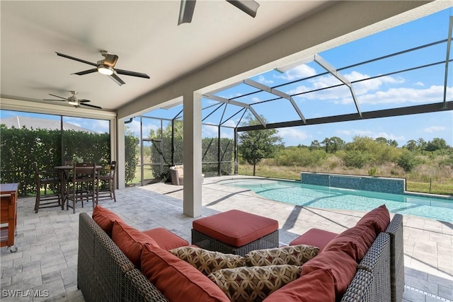 view of patio / terrace with pool water feature, an outdoor hangout area, glass enclosure, and ceiling fan