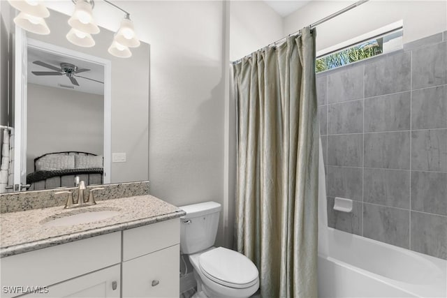 full bathroom featuring vanity, ceiling fan, toilet, and shower / tub combo with curtain