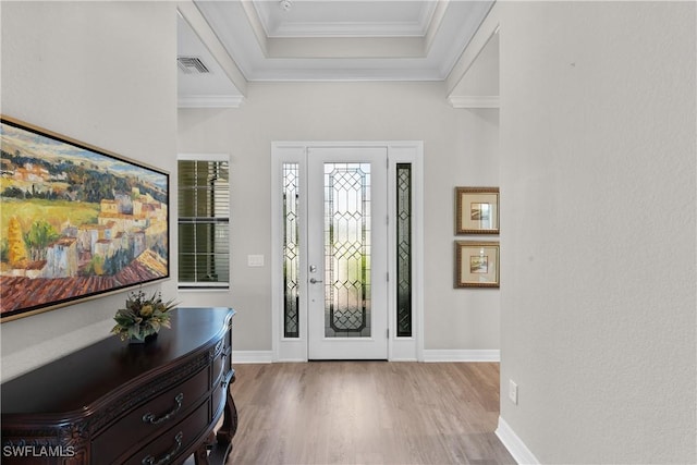 foyer featuring light wood-type flooring and crown molding