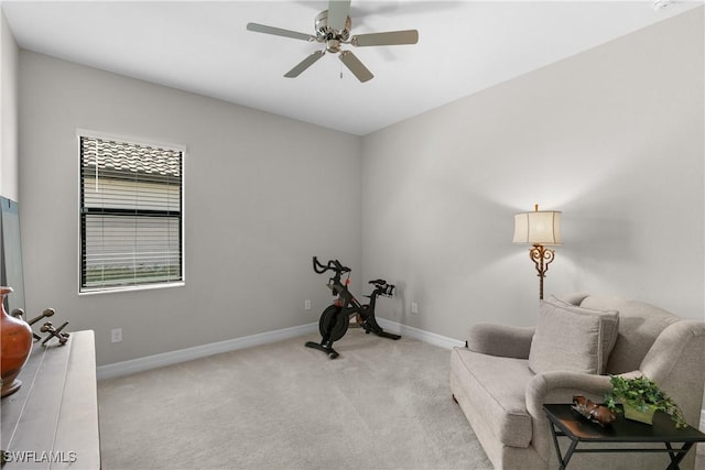 living area featuring ceiling fan and light colored carpet