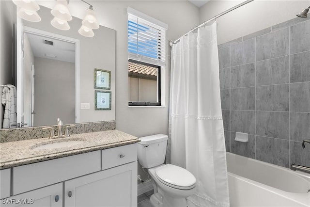 full bathroom with vanity, shower / tub combo, and toilet