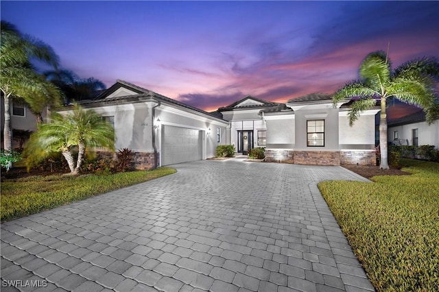 view of front of house with a yard and a garage