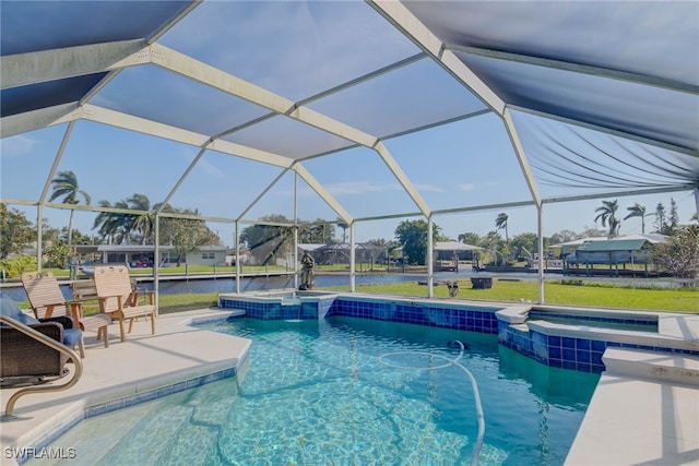 view of pool featuring glass enclosure, an in ground hot tub, a patio area, and a water view