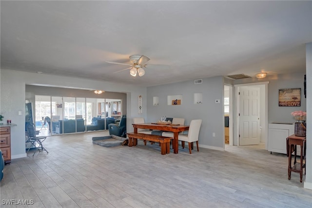 dining area with ceiling fan and light hardwood / wood-style floors