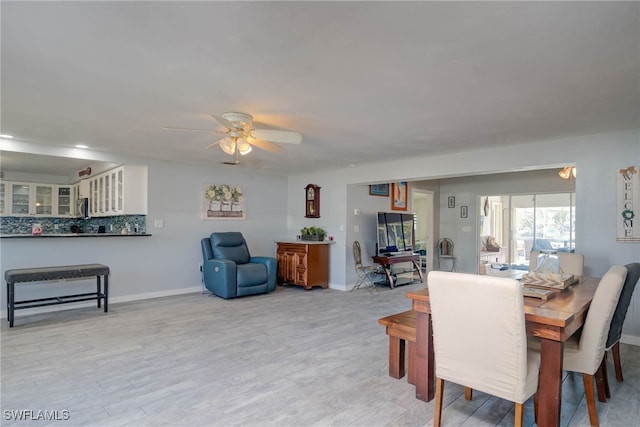 dining space featuring ceiling fan and light hardwood / wood-style floors