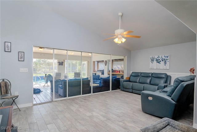 living room with light hardwood / wood-style flooring, ceiling fan, and lofted ceiling