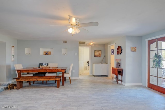 dining area with ceiling fan and light wood-type flooring